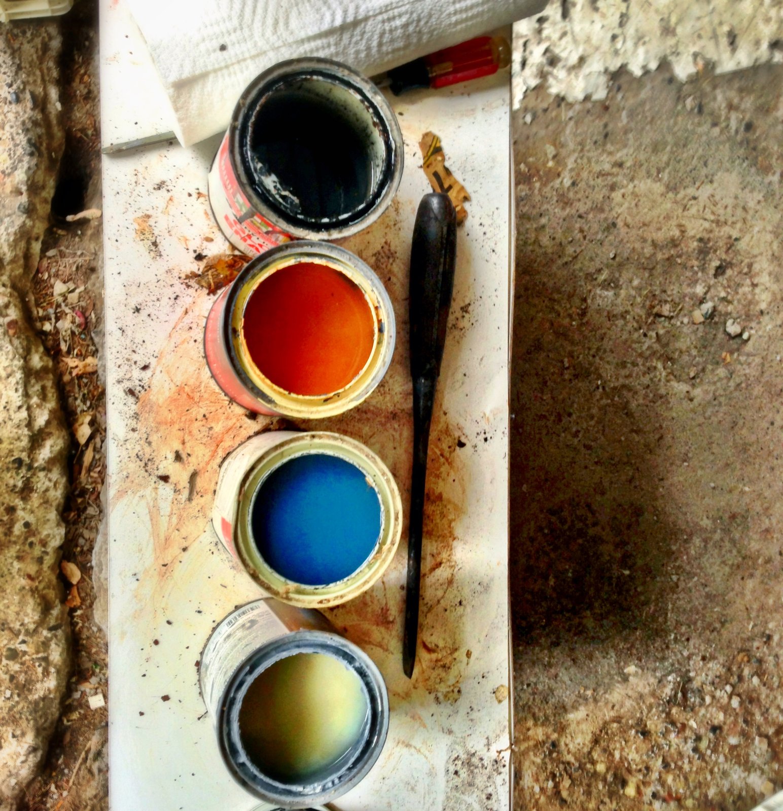 Four used paint cans, photographed in Syracuse, New York, in 2013. Photo illustrates leftover paint, not disposal instructions.