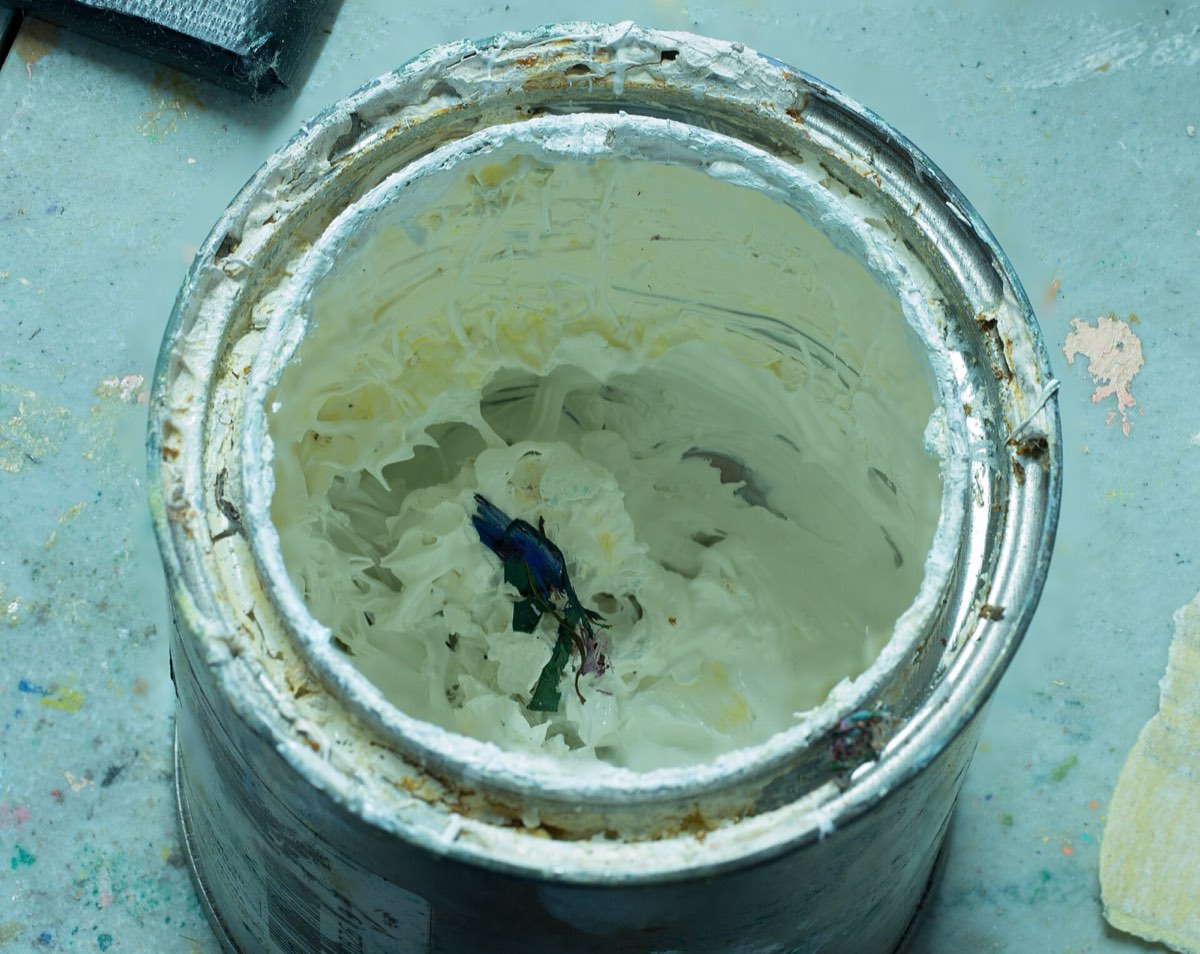 An opened can of old paint.