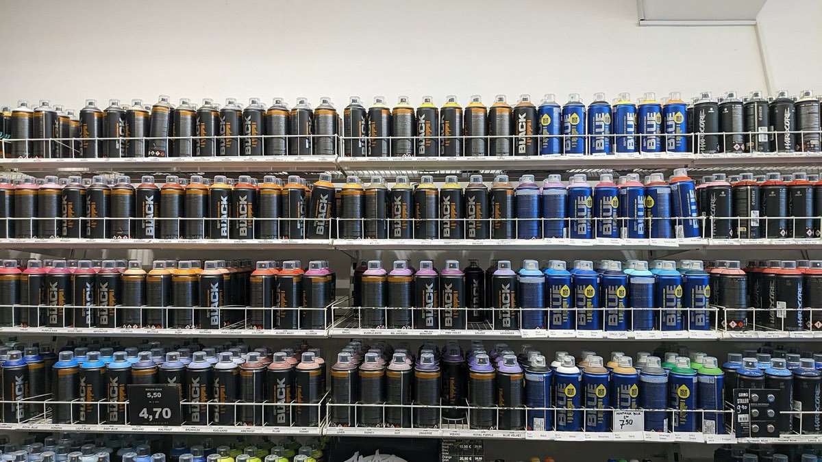 Spray paint cans on a store shelf.